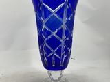 a blue glass vase on a clear base on a white background