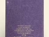 a close up of a purple book on a white surface