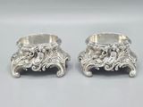 pair of silverplated candlesticks with a lion head on each of them