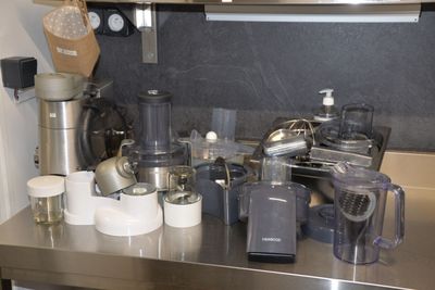 stainless steel counter top with a bunch of kitchen appliances on it