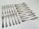 many forks and spoons laid out on the table