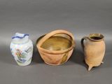 three different types of pottery sitting on a table