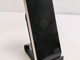 a cell phone that is on a stand on a table