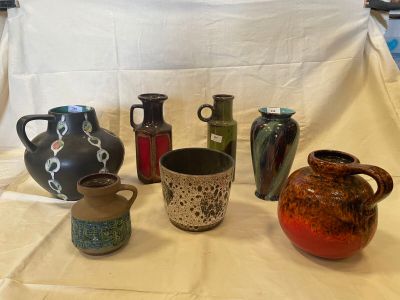 a lot of vases that are sitting on a table