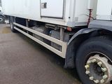 a truck that is parked in a lot with other trucks in the background