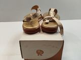 pair of women ' s sandals in a box on a white surface