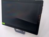 a tablet computer sitting on a stand on a white surface
