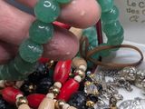 a person holding a bunch of beads in a box