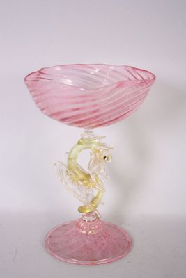 a pink glass bowl with a gold fish on it