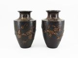 two vases that are sitting side by side on a white surface