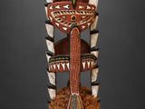 an image of a wooden totema with horns on it