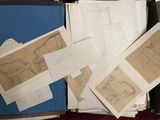 a lot of drawings in a suitcase on the floor