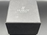 a close up of a watch in a black box on a table