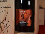 a bottle of red wine sitting in a wooden box