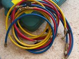 a bunch of hoses that are on the ground next to a laptop