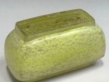 a green vase that is sitting on a table