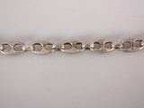 a close up of a silver chain on a white surface