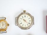 three different types of watches displayed on a white surface