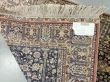 a lot of rugs on display on the floor