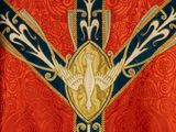 an image of a close up of a cross on a red and blue cloth