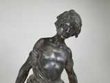 statue of a boy with a bowl of fruit in his hands