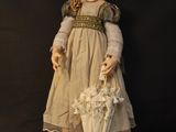 a doll that is holding an umbrella on a black background