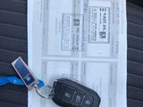 a car key sitting on top of a piece of paper on the seat of a car