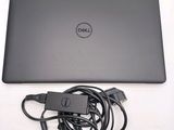 dell laptop with power cord plugged into the back of it