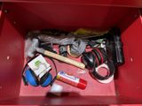 a red box filled with assorted items and tools