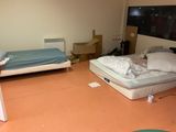 a room with a bed and a desk in it