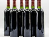 six bottles of wine are lined up in a row