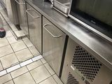 a picture of a commercial kitchen with a lot of counter space
