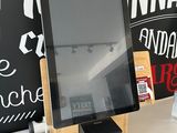a tablet that is on a table in front of a chalkboard