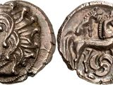 a silver coin with an image of a horse and a man on it