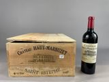 an old wooden box with a bottle of wine next to it