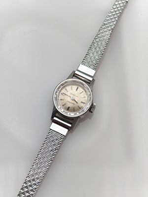 a close up of a wrist watch on a white surface