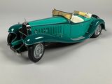 a model of a green car on a white surface