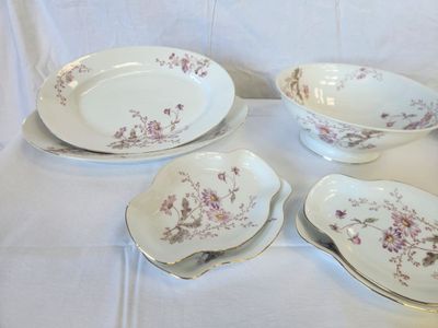 four plates and a bowl sitting on a table