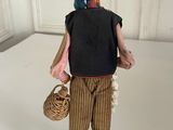 figurine of a woman with a basket on a white surface