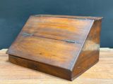 an old wooden box sitting on top of a wooden table
