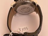 a watch that is sitting on a table with a price tag attached to it