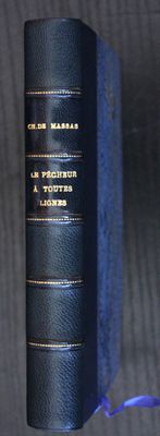 an old book with a blue cover sitting on top of a wooden table