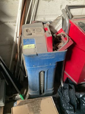 a red trash can and a blue trash can in a garage