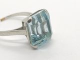 an image of a ring with a blue topazt stone in it