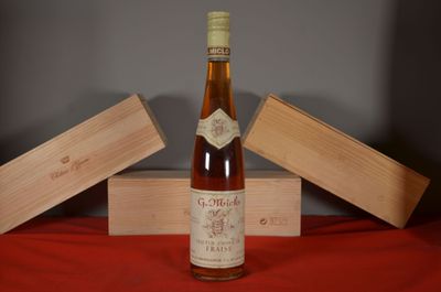 a bottle of wine sitting on a table next to a box