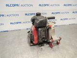 a small engine is sitting on the floor in front of a wall