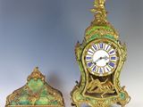 two clocks sitting next to each other on a table