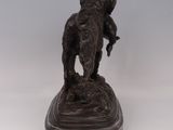 bronze statue of a man riding an elephant on a marble base
