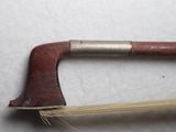 a wooden handle with a metal handle on a white surface
