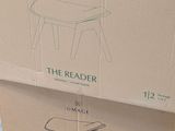 cardboard box with a drawing of a stool on top of it